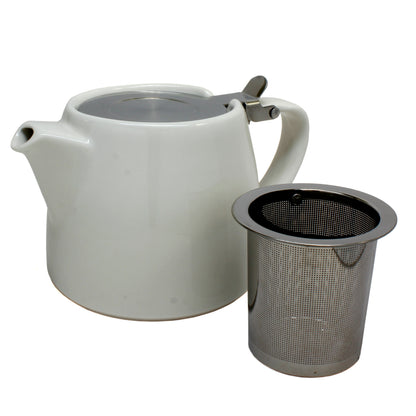 White ceramic teapot with a strainer on the side on a white background. 