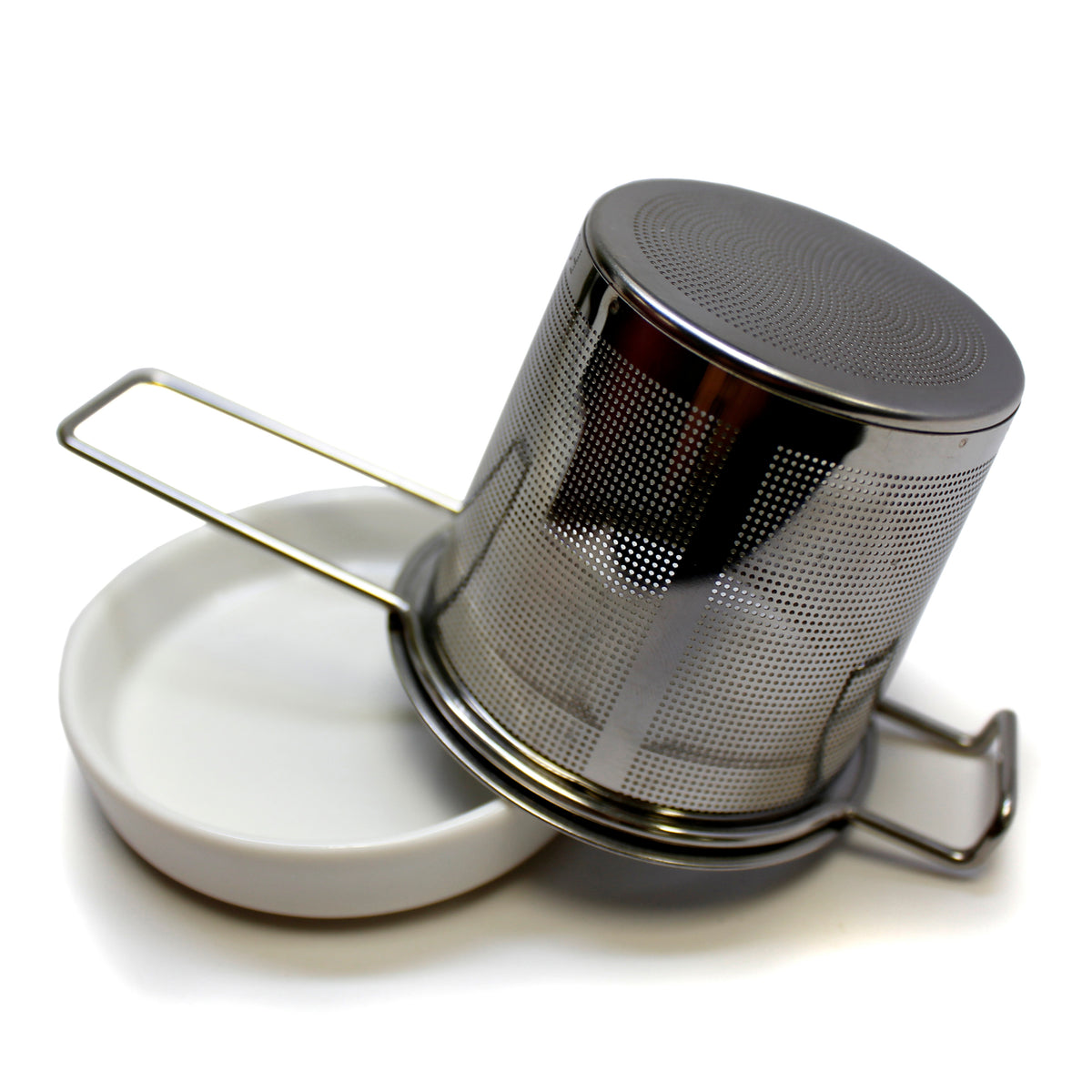 Dry strainer upside down on a white dish on a white back ground. 