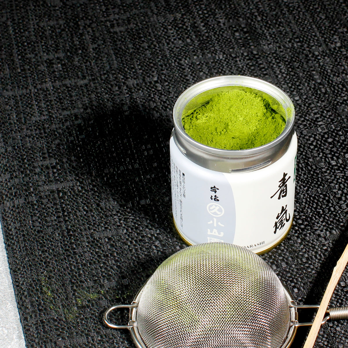 Aoarashi Ingredient Grade Matcha - Marukyu Koyamaen - Uji, Kyoto, Japan - open tin on a table cloth, shifter in the foreground. Tasting Notes:
baby spinach • cucumber • split pea