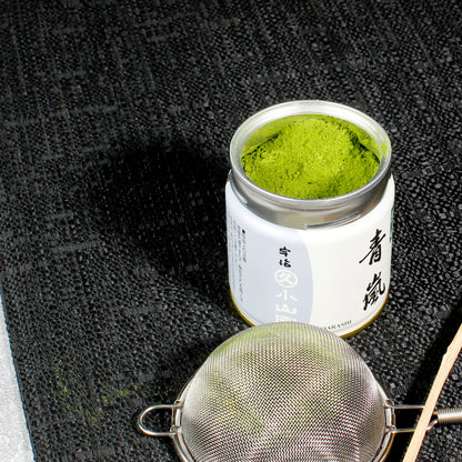 Aoarashi Ingredient Grade Matcha - Marukyu Koyamaen - Uji, Kyoto, Japan - open tin on a table cloth, shifter in the foreground. Tasting Notes:
baby spinach • cucumber • split pea