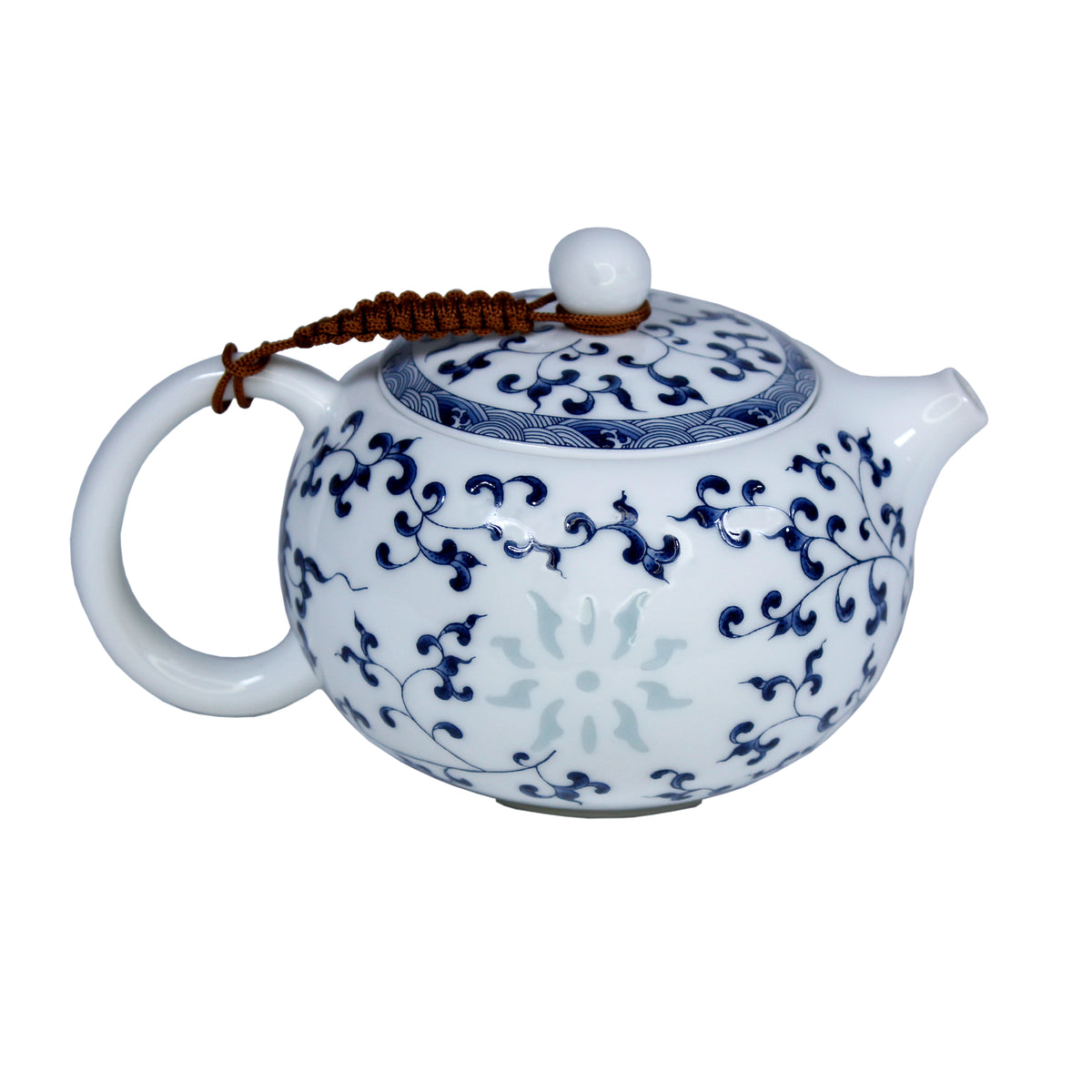 Ceramic teapot with blue floral and leaf patterns, a slightly transparent sun is on the side. A brown braided rope holds the lid to the handle. The tea pot is on a white background