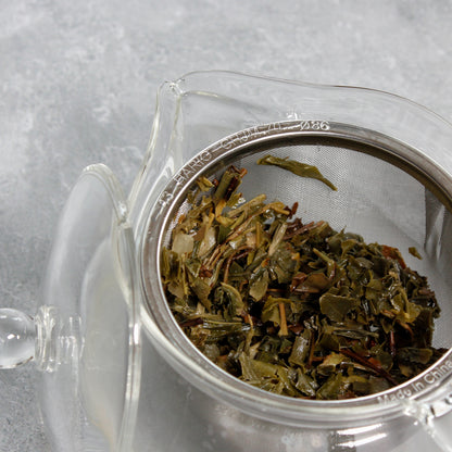 Inward shot of wet tea leaves in the glass Hario teapot.  