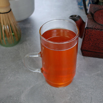 Pumpkin Spice - infusion in a tall glass, a square red tea pot and matcha whisk in the background. Tasting Notes:
cinnamon • nutmeg • pumpkin