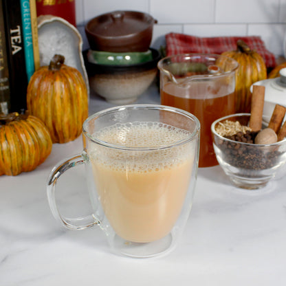 Pumpkin Spice - latte made with milk. Fall decor behind it. Tasting Notes:
cinnamon • nutmeg • pumpkin 